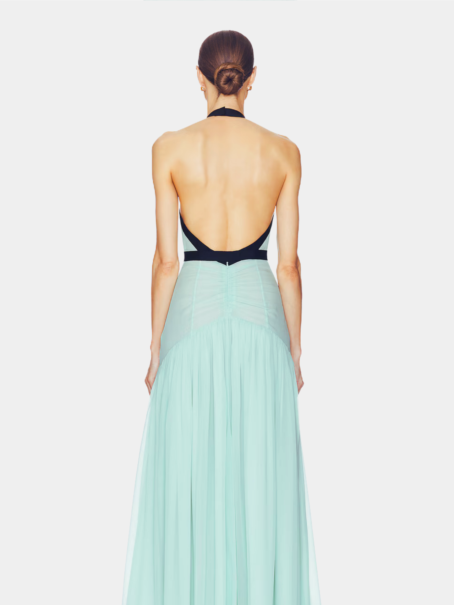 Back view of mint maxi dress showing open backless design