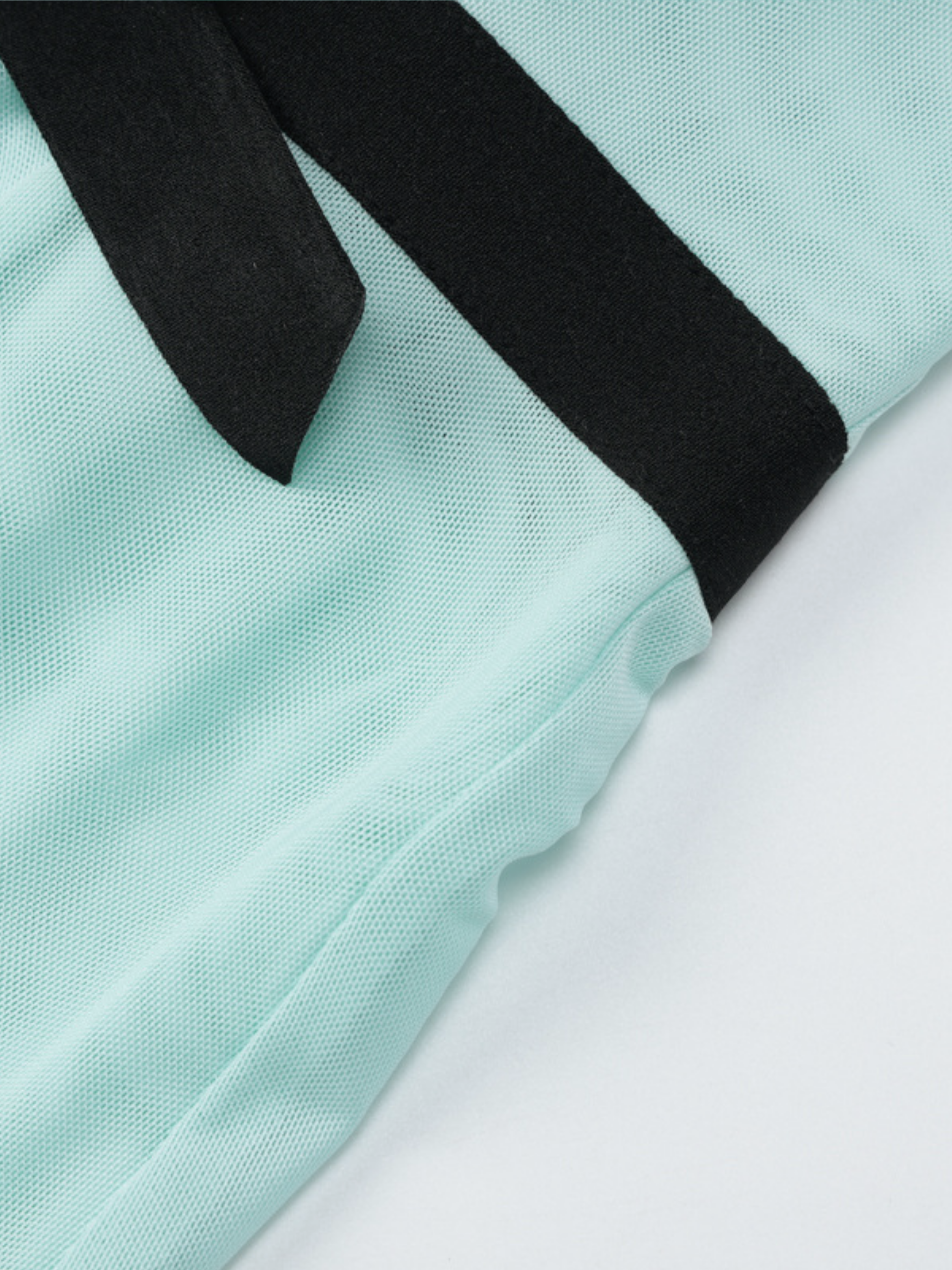 Black halter straps on mint pleated maxi dress fabric texture