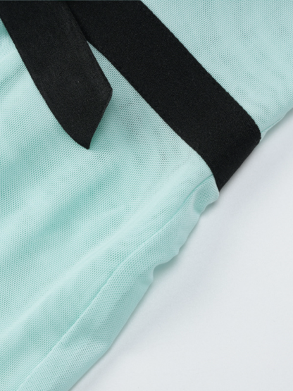 Black halter straps on mint pleated maxi dress fabric texture