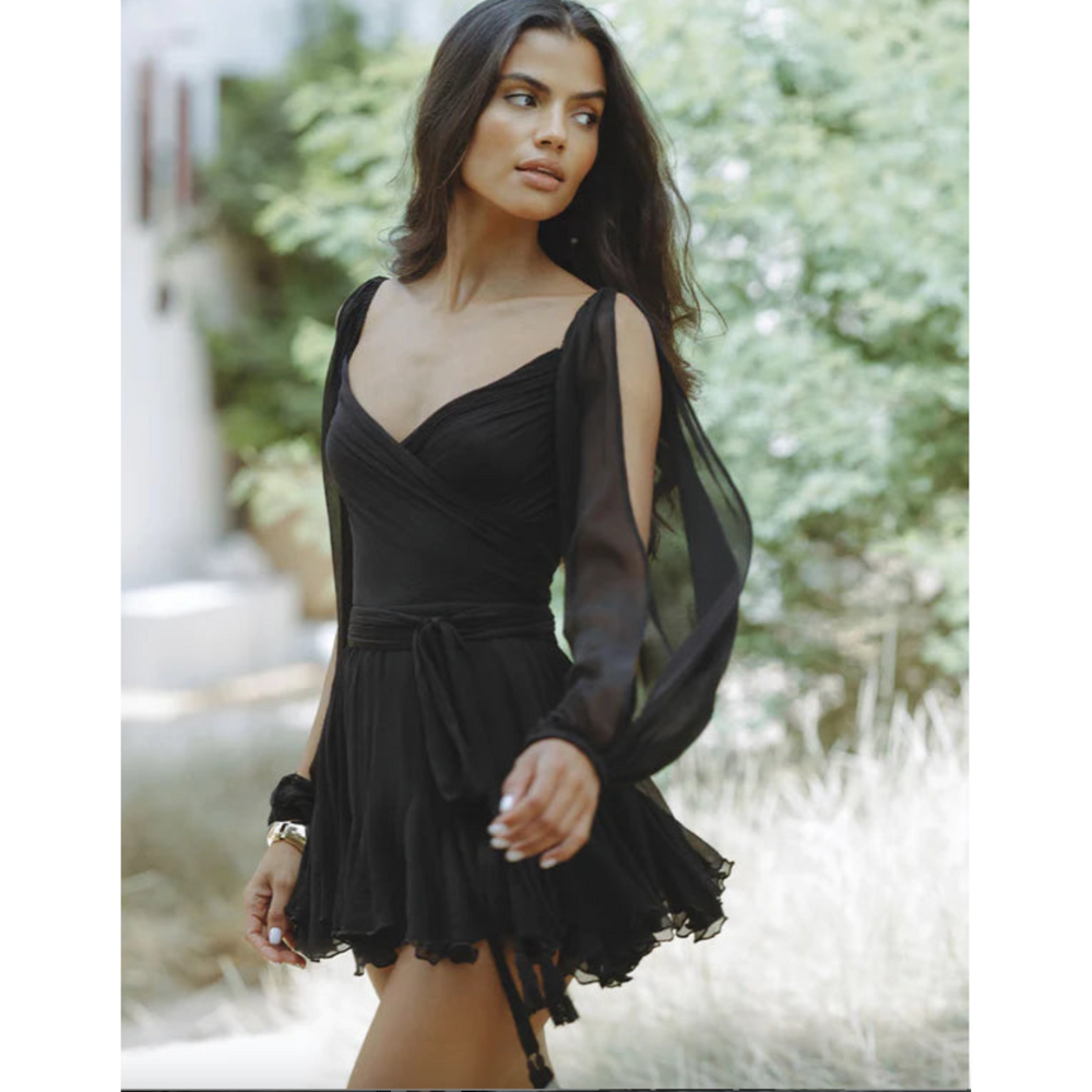Black wrap mini dress with sheer long sleeves and layered ruffle skirt