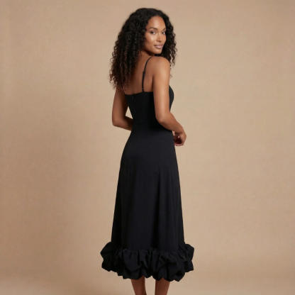 Back view of black ruffle midi dress with gathered hem detail