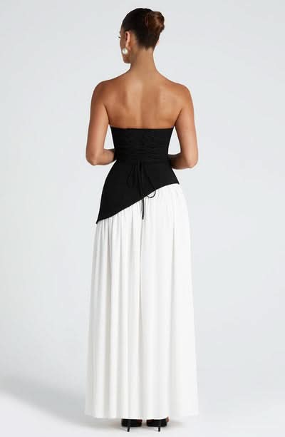 Back view of black and white wrap maxi dress with asymmetrical drape