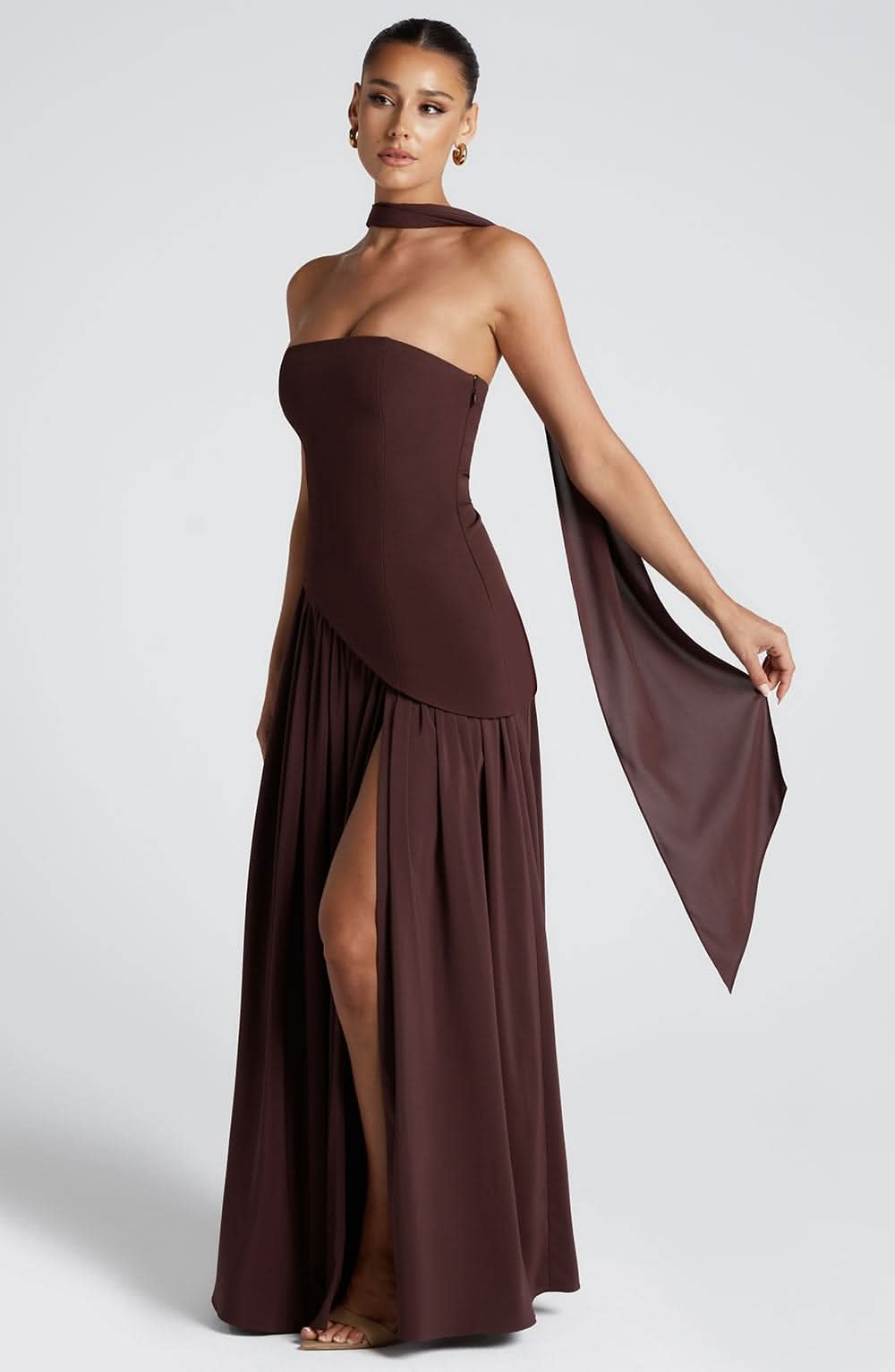 Brown strapless maxi dress with high slit and flowing draped fabric detail