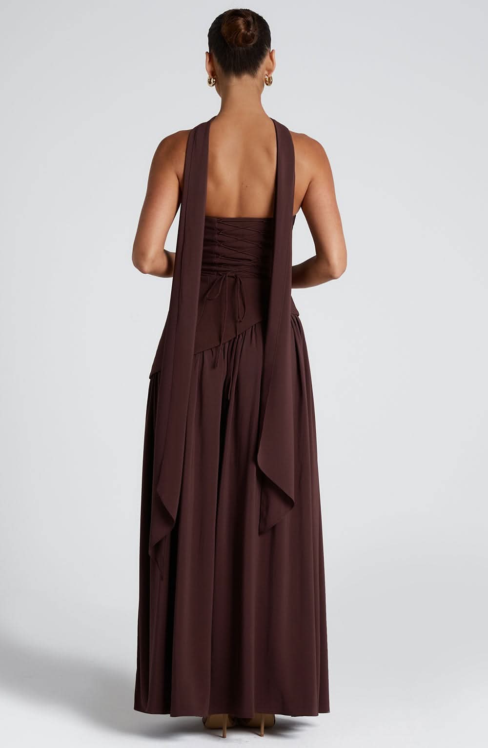 Back view of brown wrap maxi dress showing open back and draped fabric detail