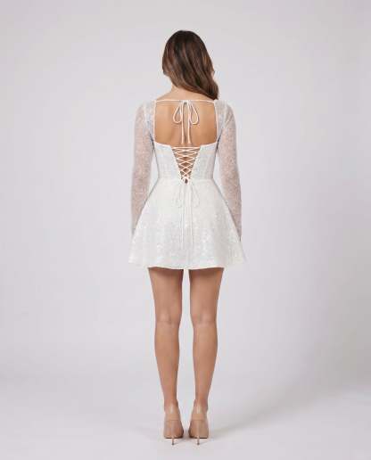 glitter white women cocktail square neck sequin mini dress back view showing open back, square neckline, lace-up corset closure, decorative ties at upper back