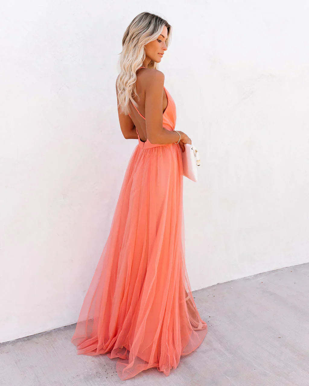 Side view of coral backless maxi dress with thin straps and layered tulle