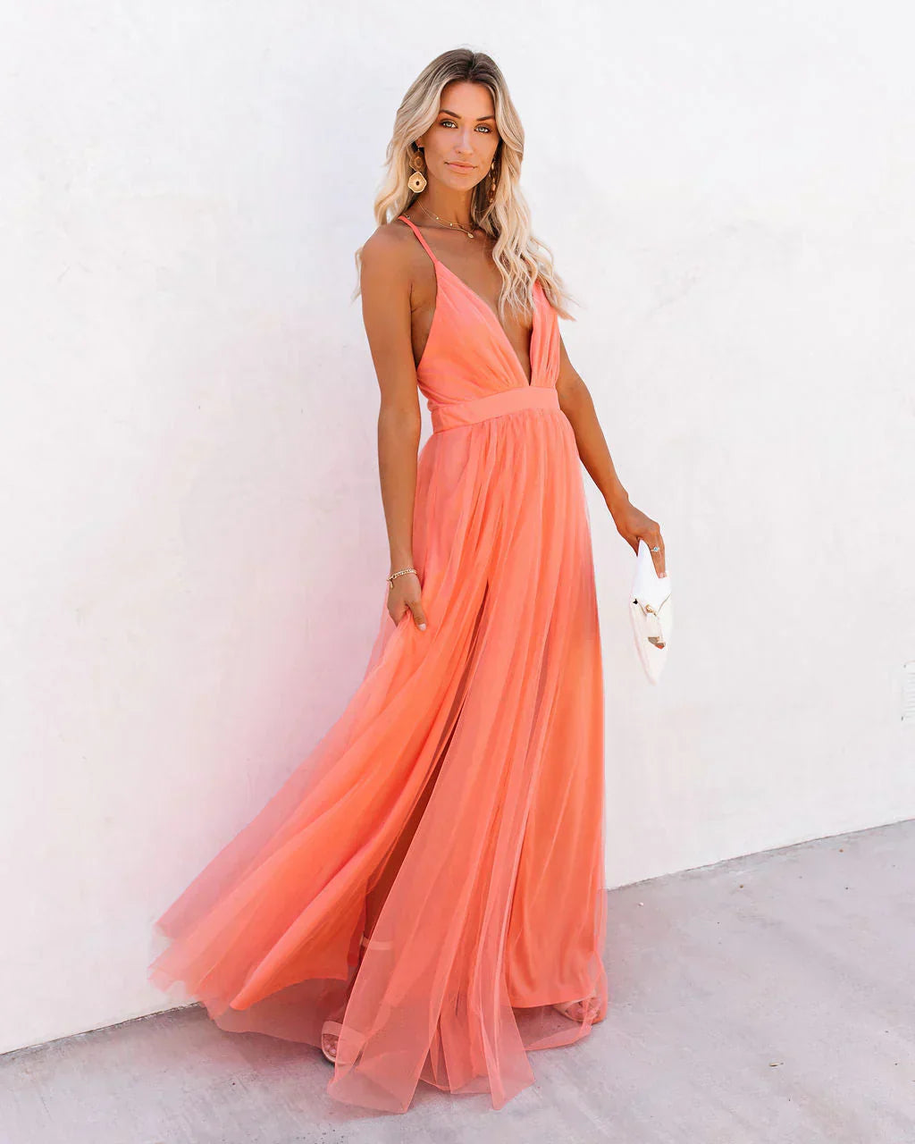Coral tulle backless maxi dress with deep V-neckline and flowing skirt