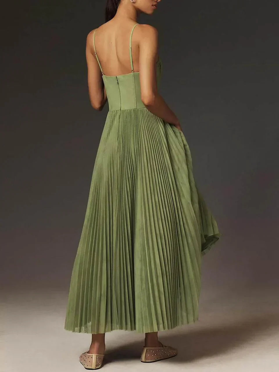 Back view of sage pleated maxi dress showing open back and full skirt