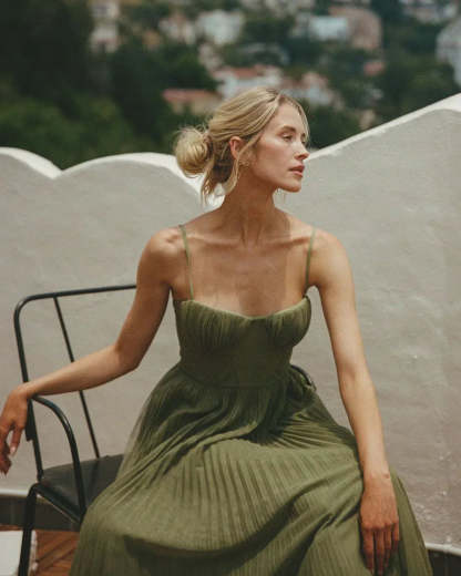 Side profile of sage green maxi dress with pleated skirt detail