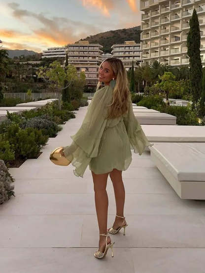 Back view of sage green ruffle mini dress with tiered ruffled sleeves