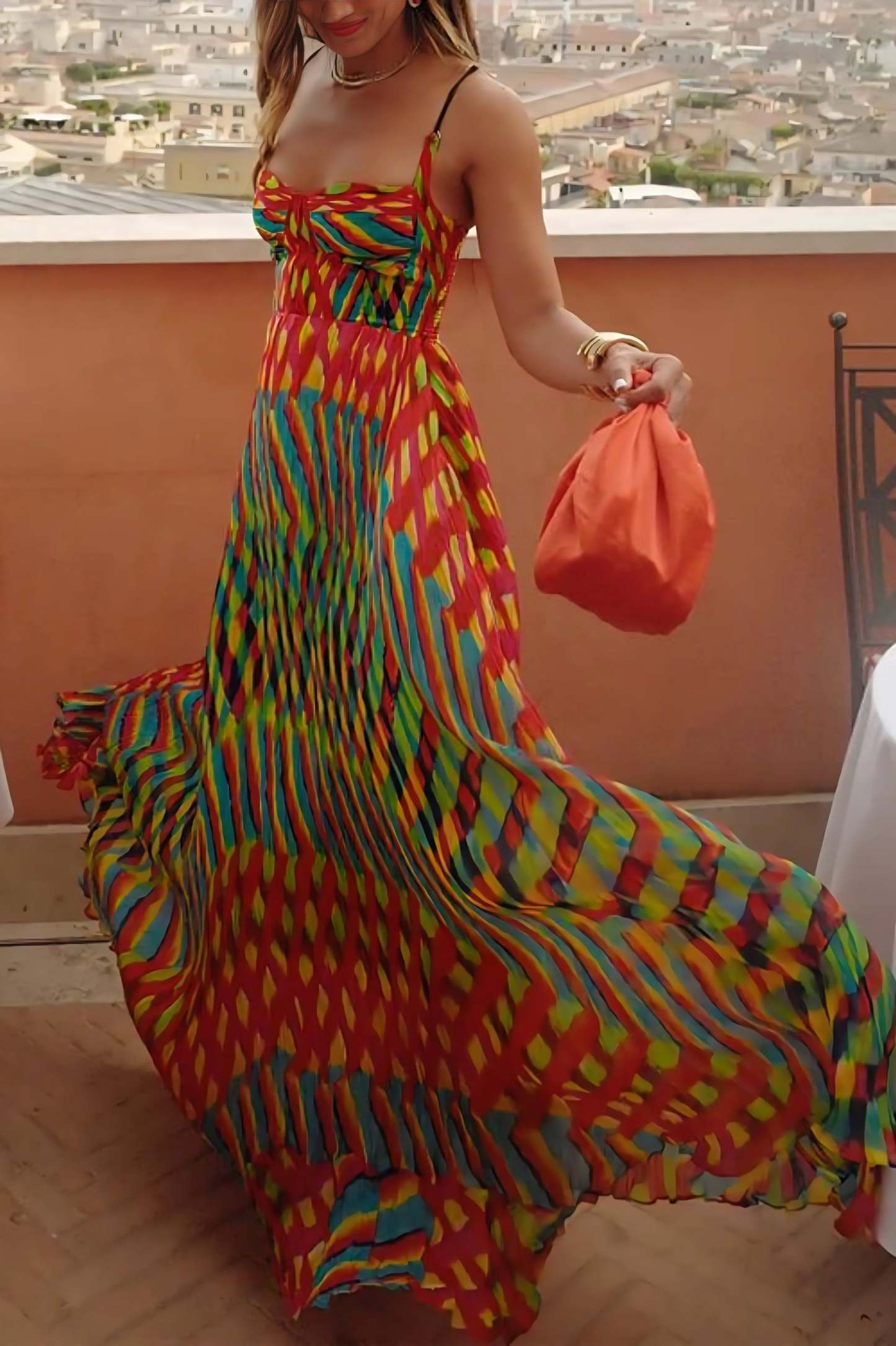 Full length pleated maxi dress with colorful geometric pattern and dramatic train detail