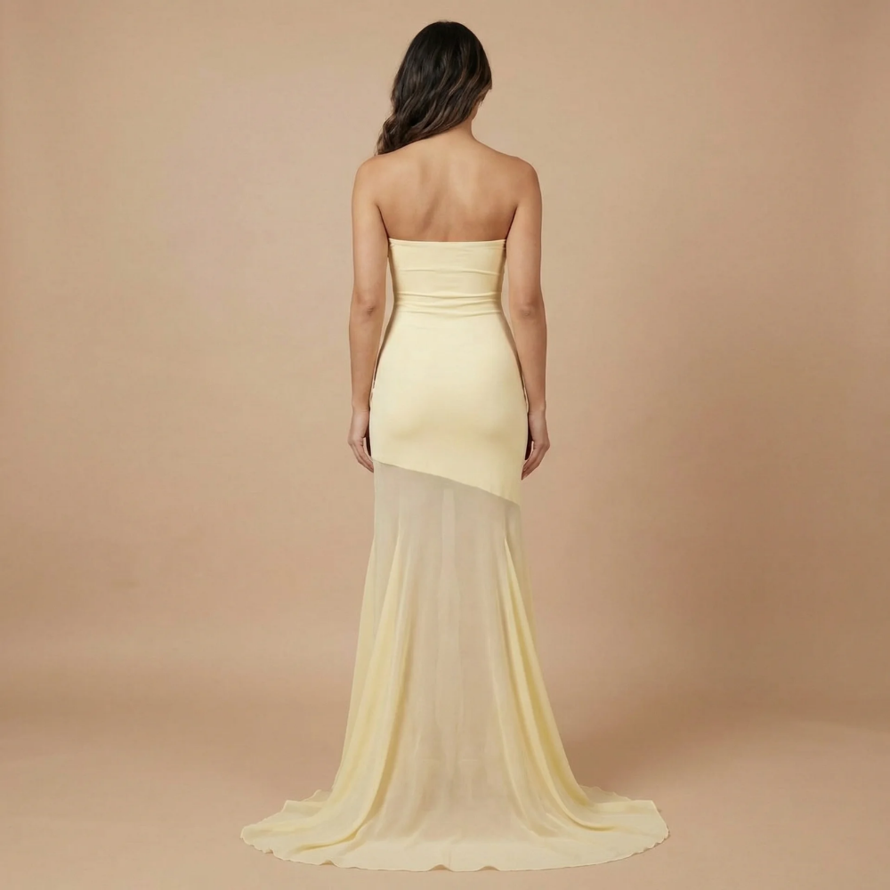 Back view of cream strapless maxi dress with mesh train