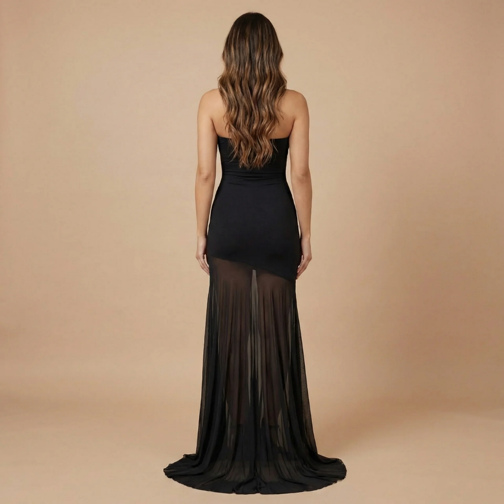 Back view of black strapless maxi dress with sheer mesh skirt