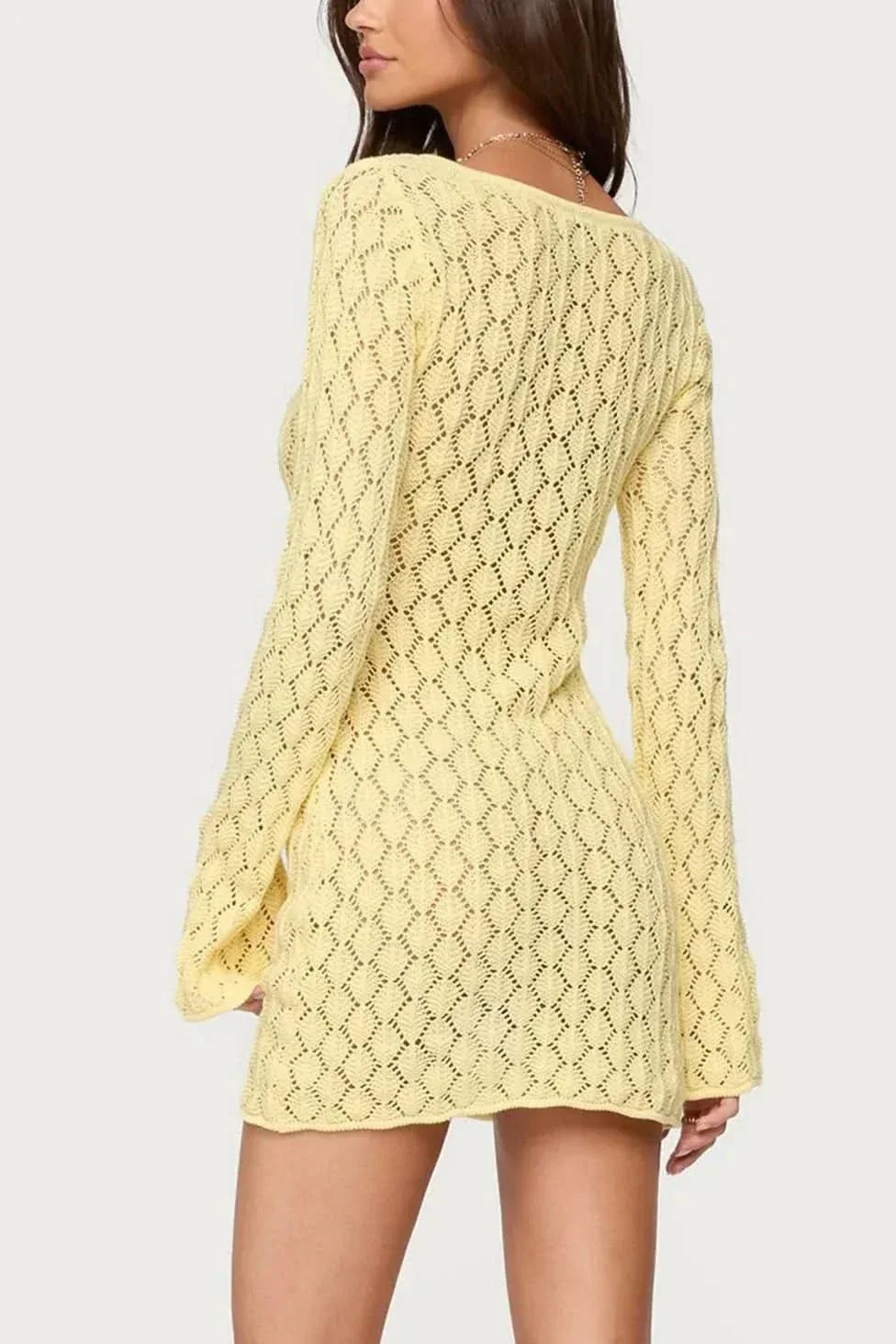 Back view of yellow crochet tie-front dress showing open weave knit construction