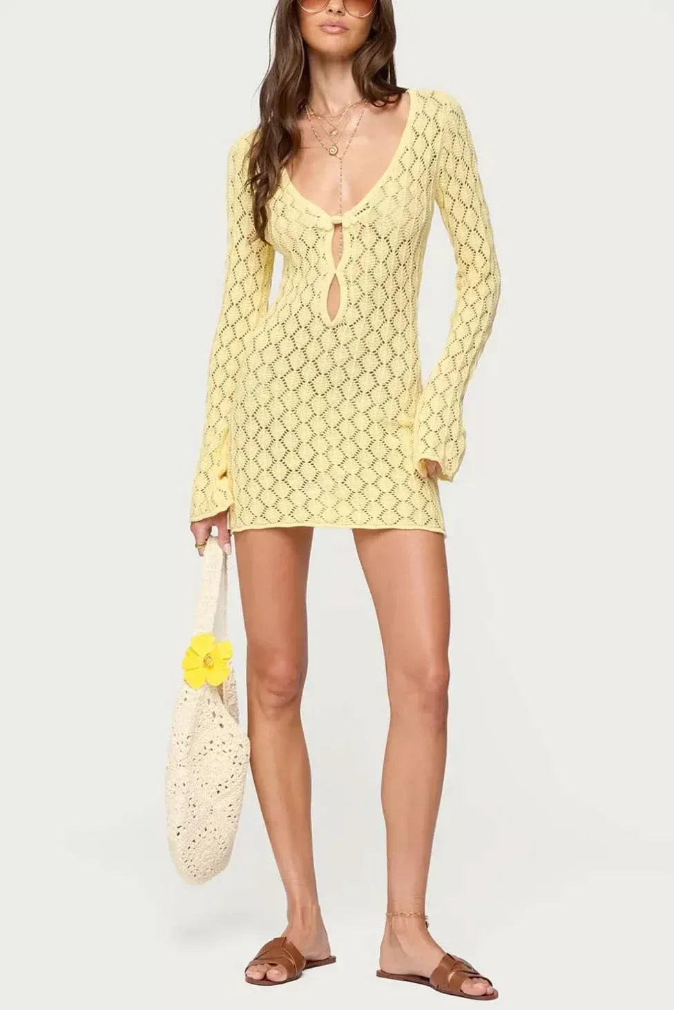 Yellow mini dress with tie-front closure, bell sleeves, and matching lace accessory