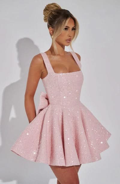 Back view of blush pink sequin dress with zip and bow detail