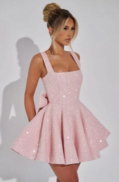 Back view of blush pink sequin dress with zip and bow detail