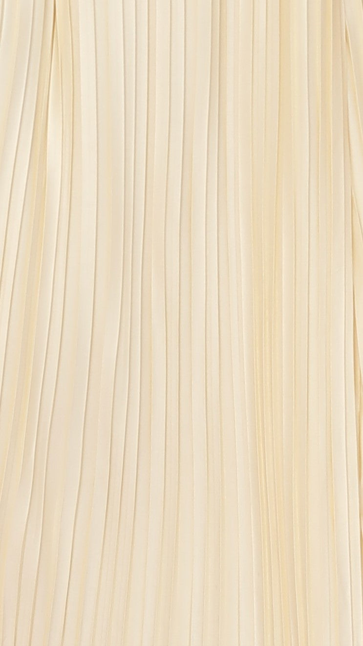 Close-up of cream vertical pleated fabric texture on maxi dress