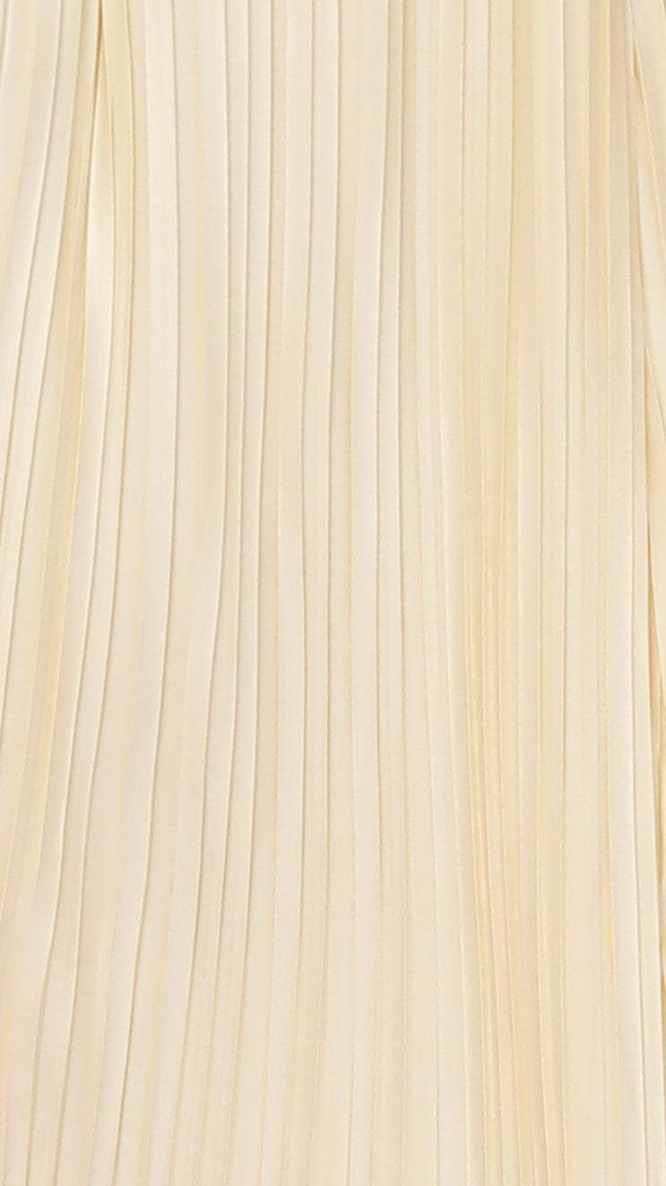 Close-up of cream vertical pleated fabric texture on maxi dress
