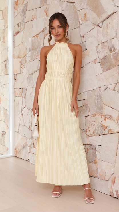 Cream pleated halter maxi dress with cinched waist and floor-length skirt
