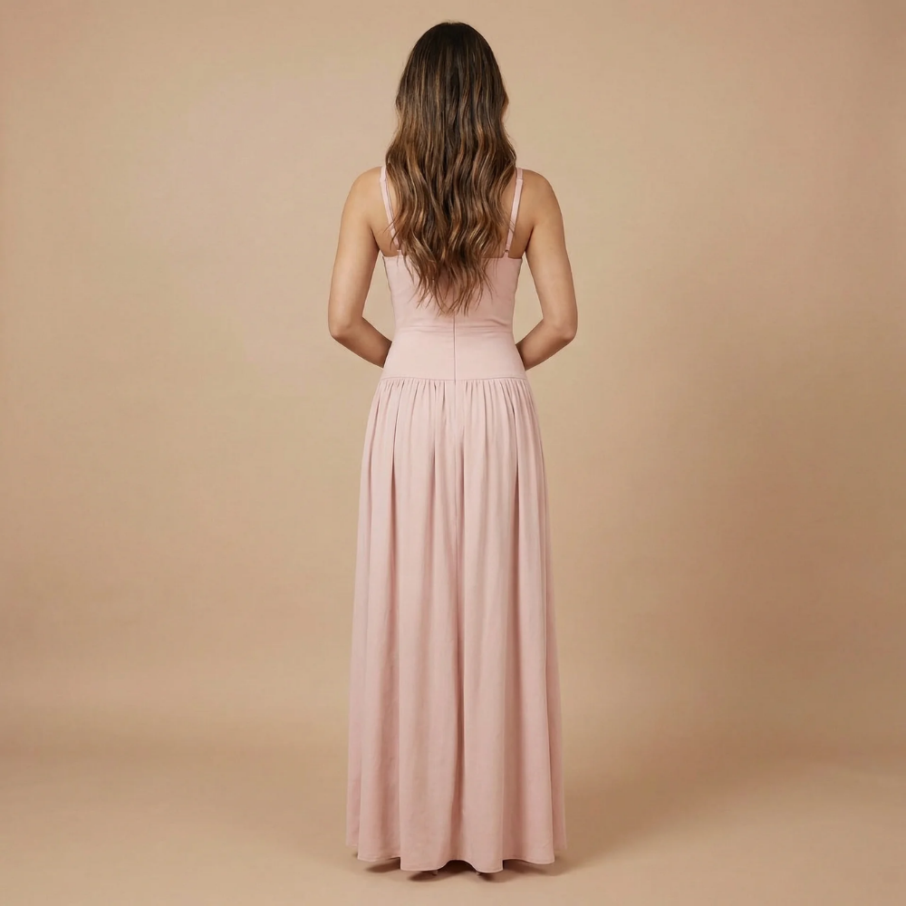 Blush pink formal maxi dress back view with open back and flowing skirt detail
