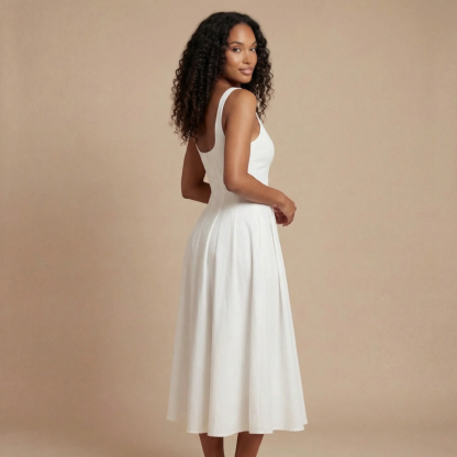 Side view of white midi dress showing open back and midi length silhouette