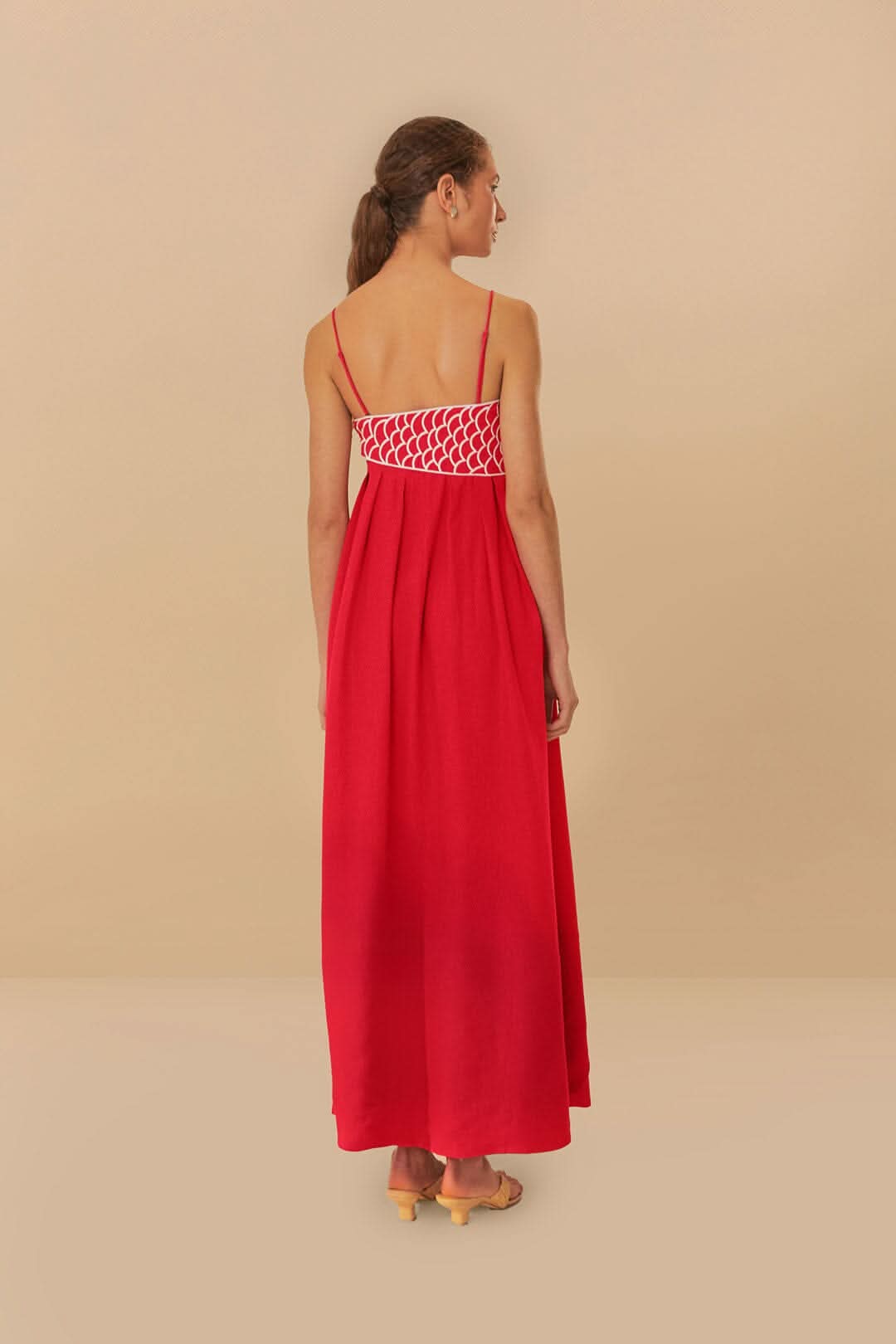 Back view of red maxi dress showing fish scale pattern and straps