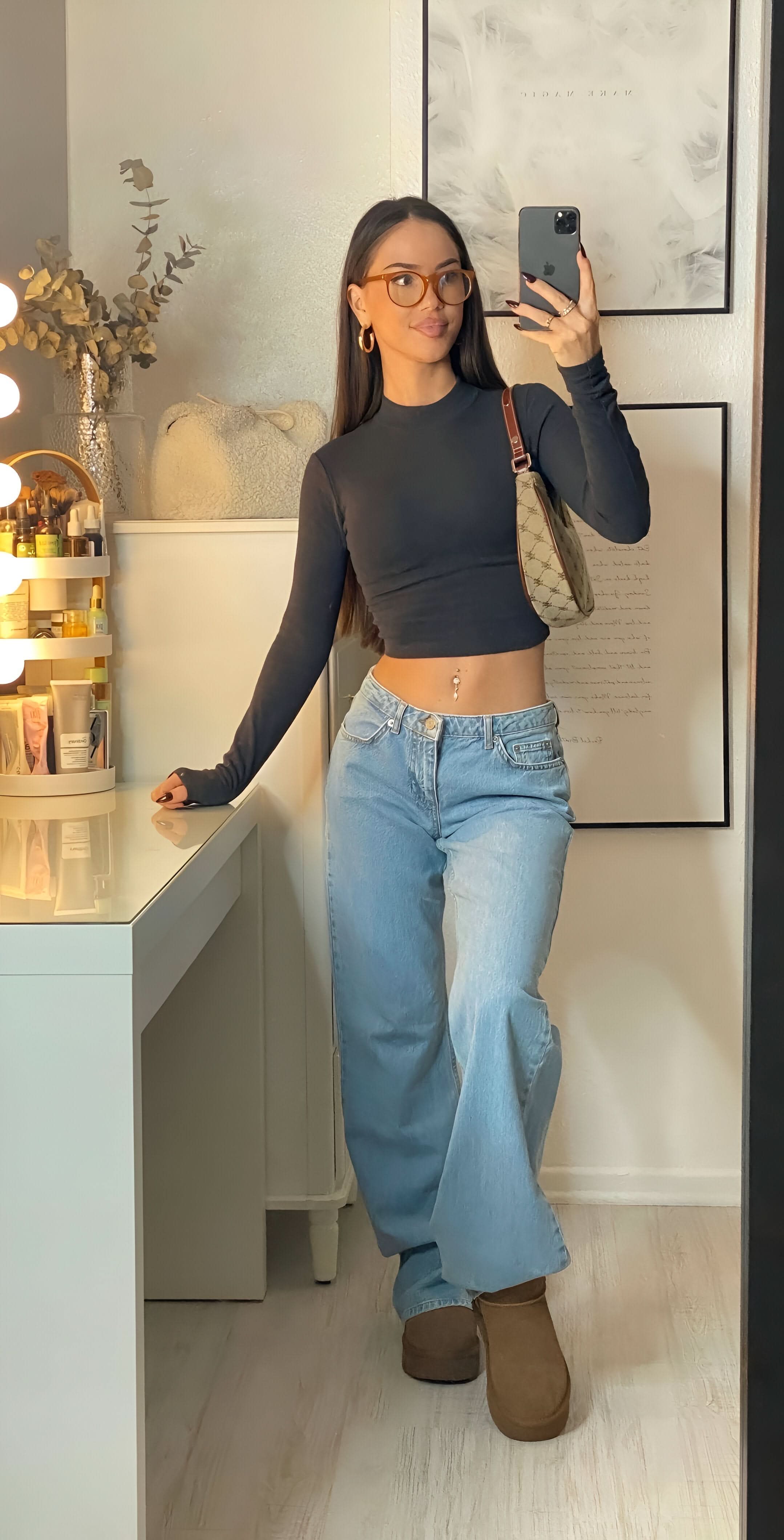 Medium wash wide leg jeans paired with black long sleeve top