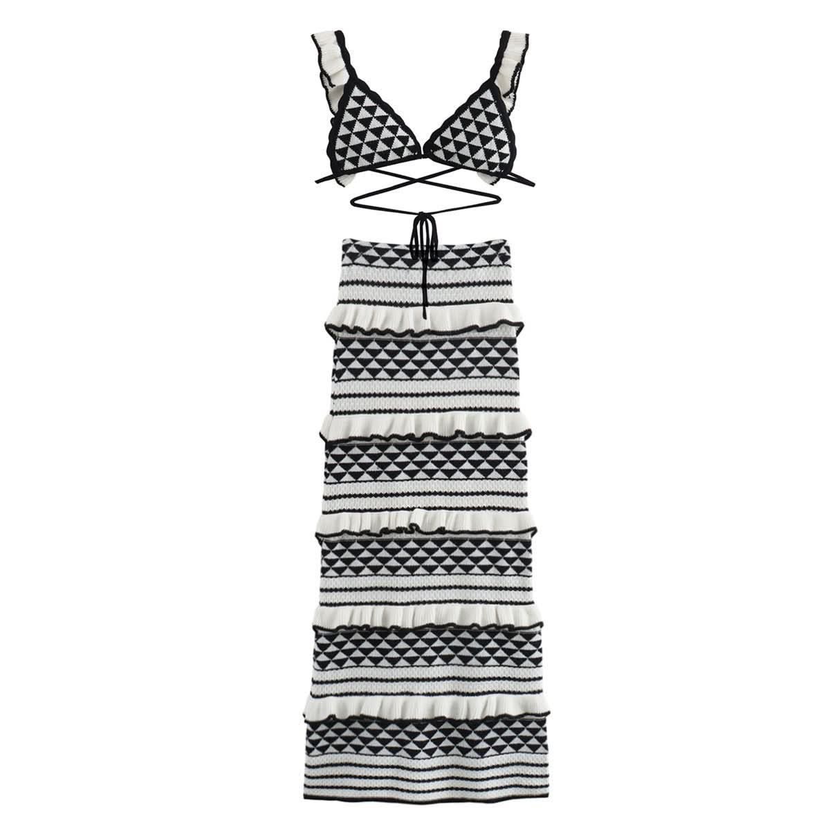 Flat lay of black and white geometric knit bikini top and tiered midi skirt with diamond patterns