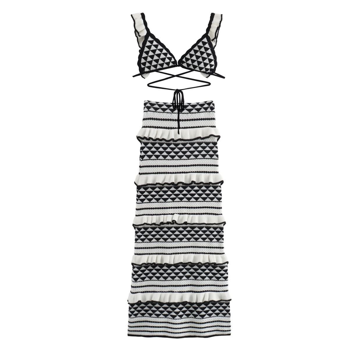 Flat lay of black and white geometric knit bikini top and tiered midi skirt with diamond patterns