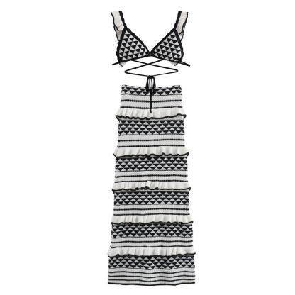Flat lay of black and white geometric knit bikini top and tiered midi skirt with diamond patterns