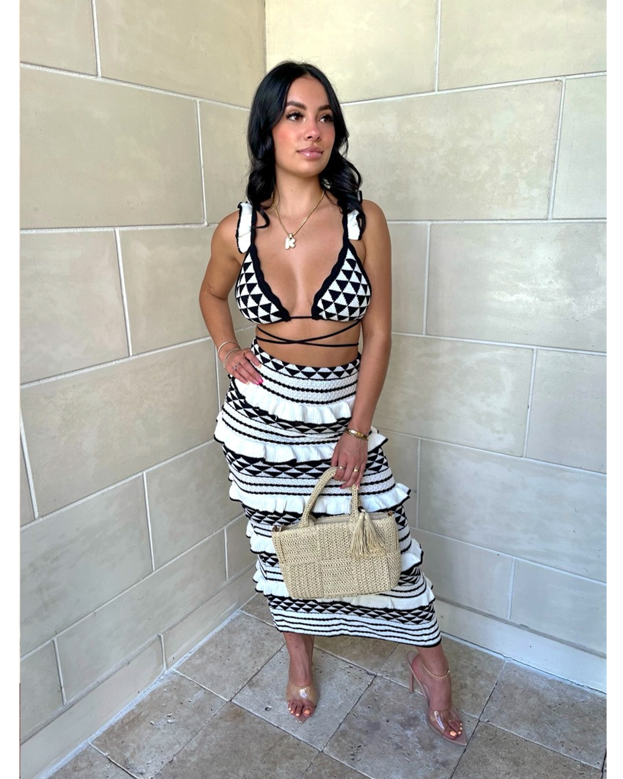 Black and white geometric knit crop top and midi skirt set with diamond pattern and stripes