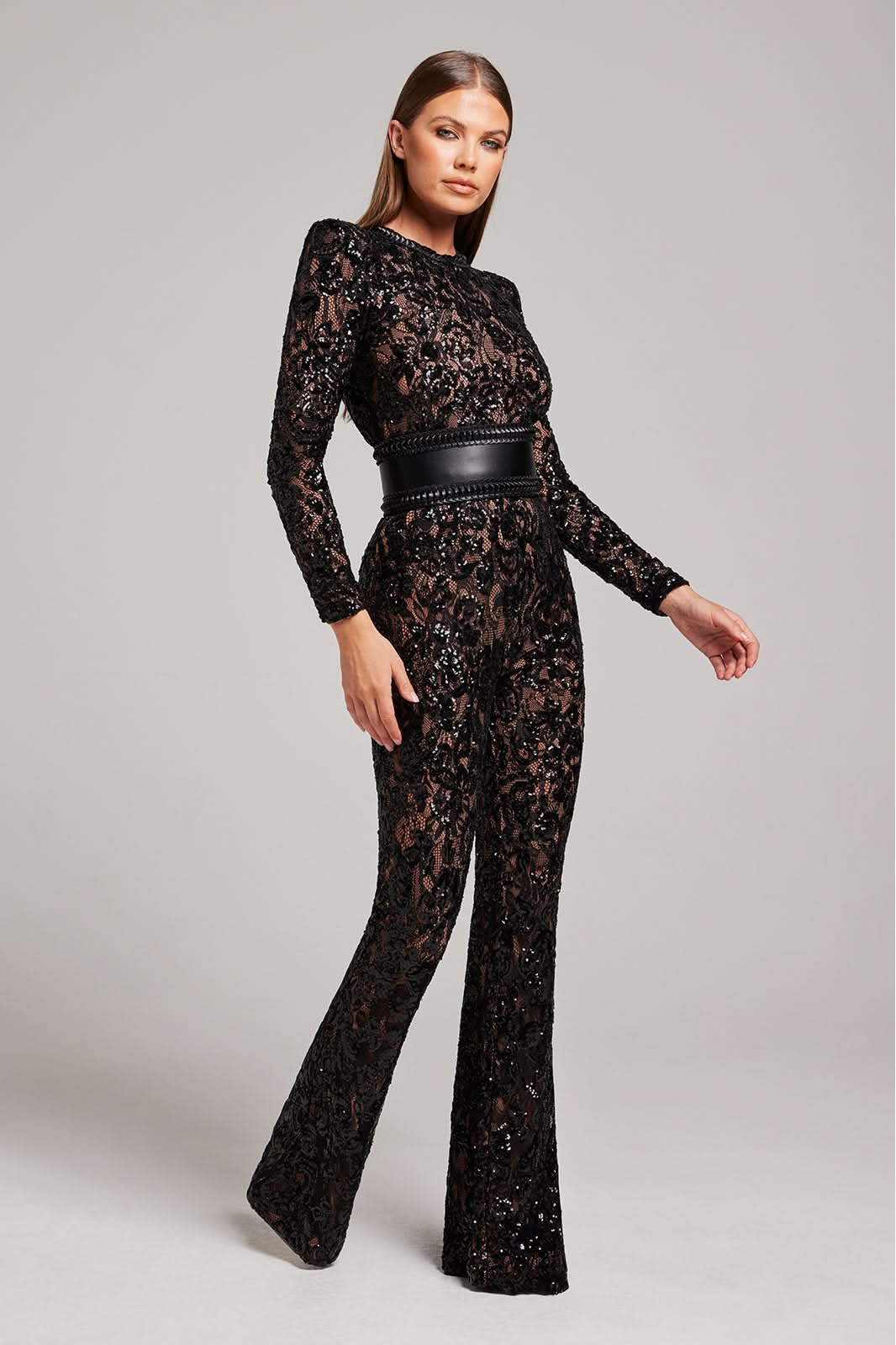 Black sequin jumpsuit side view showing fitted bodice and flared pants