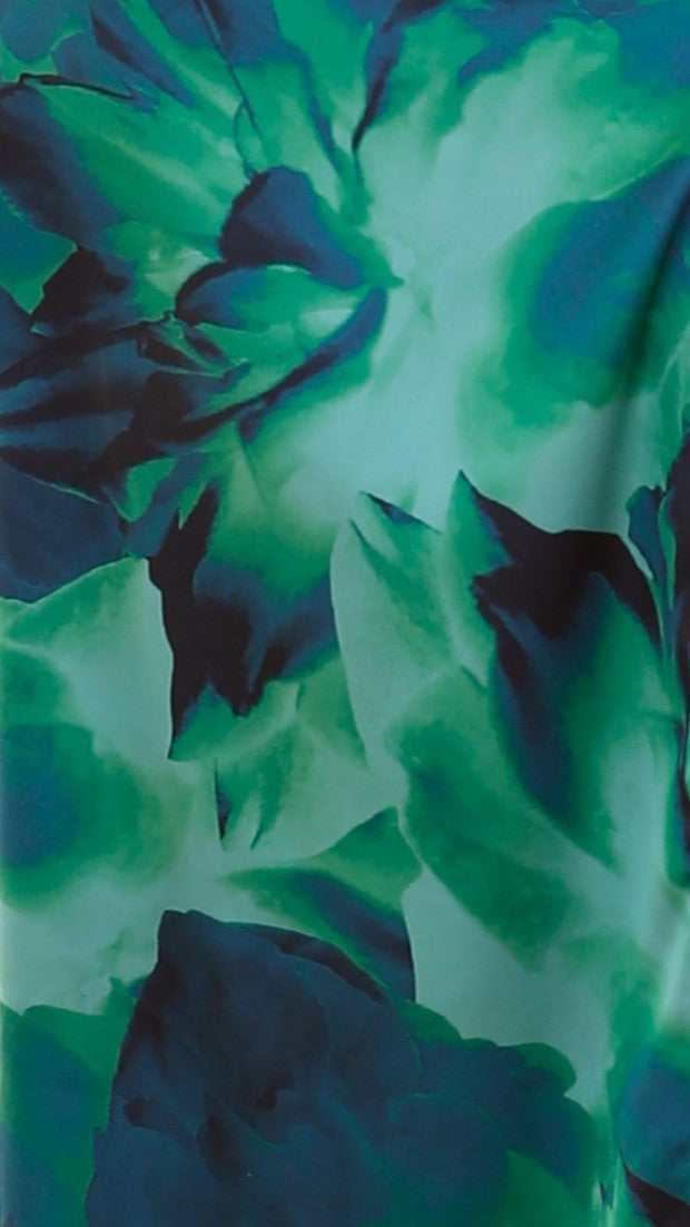 Close-up of green and navy tropical floral print fabric texture
