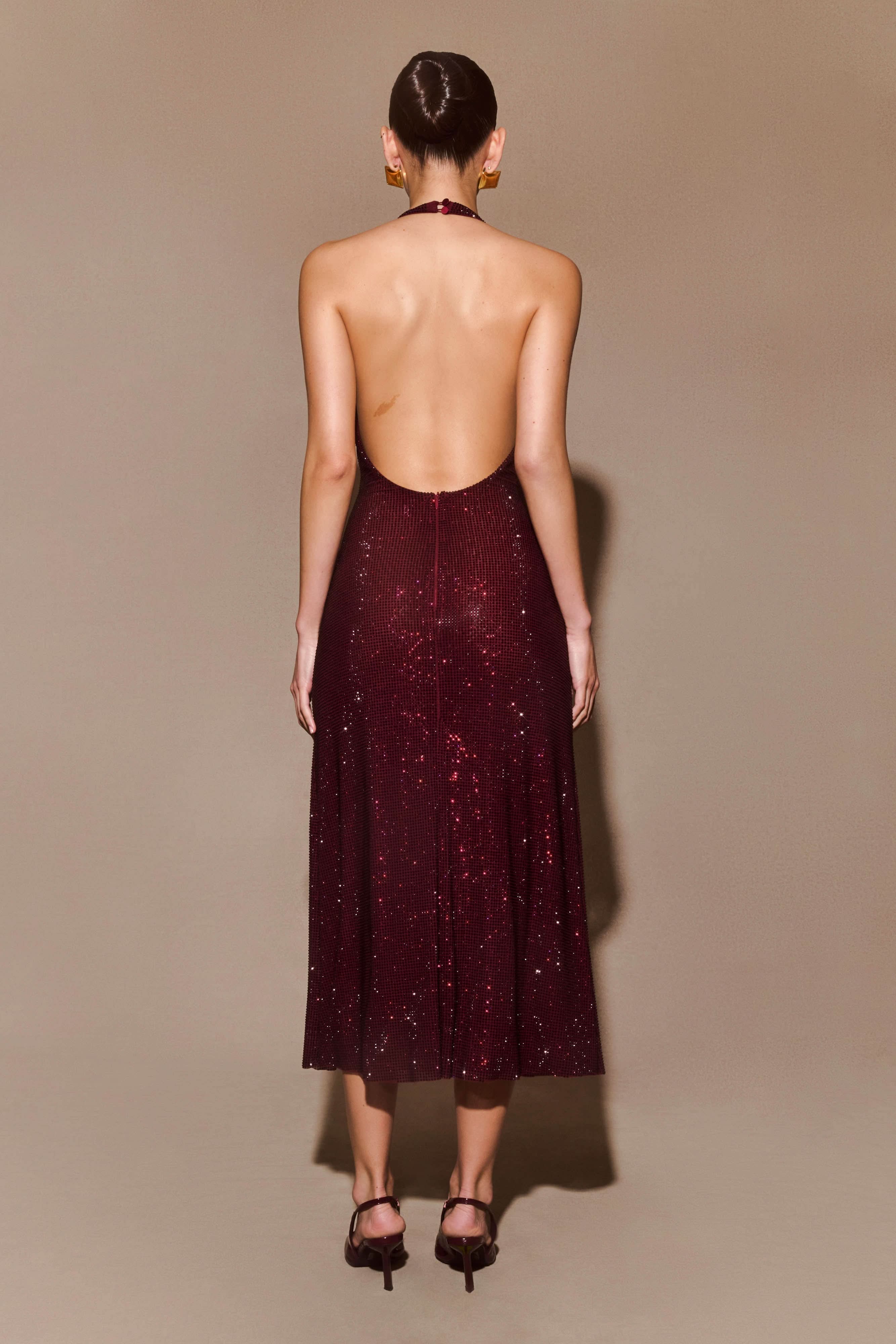 Back view of burgundy sequin midi dress showing open backless cut