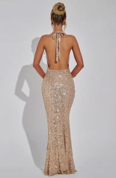 Back view of champagne beaded halter dress with open backless design
