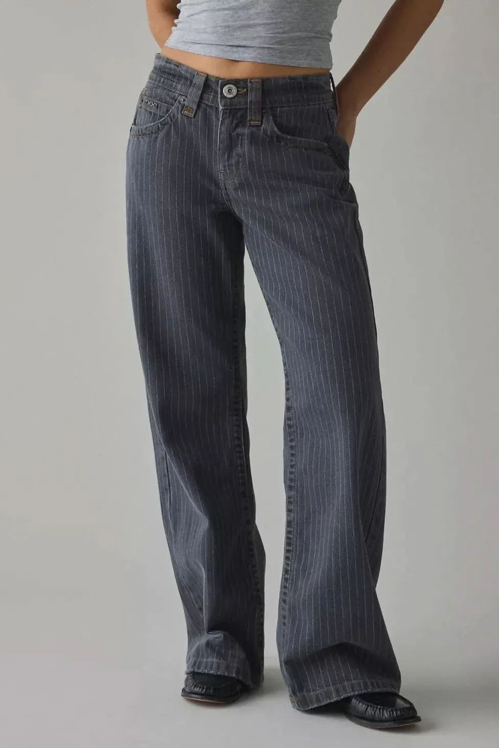 High-rise waistband detail of dark indigo pinstripe jeans with 5-pocket design