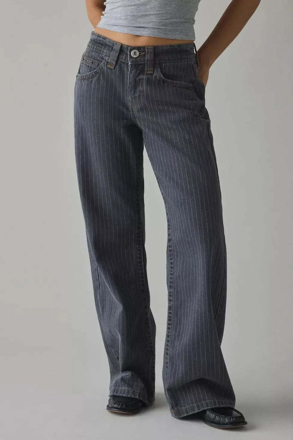 High-rise waistband detail of dark indigo pinstripe jeans with 5-pocket design