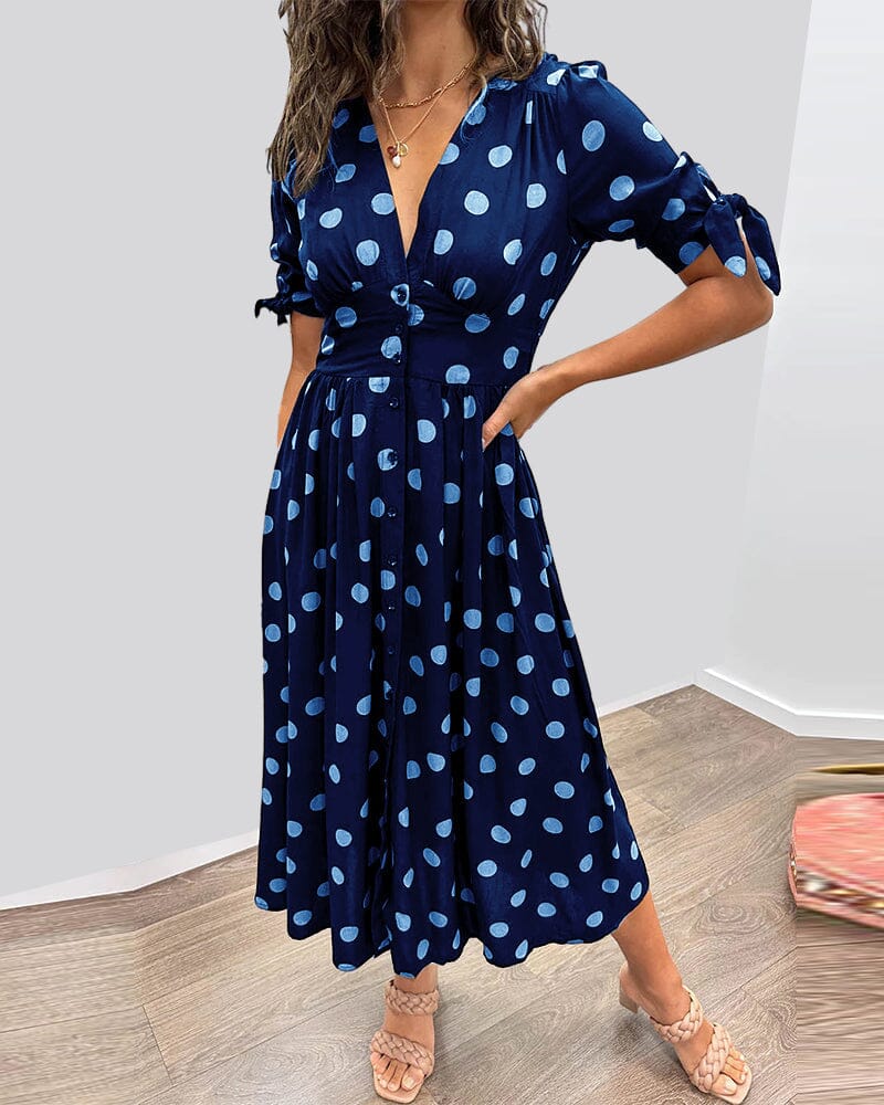 Navy blue wrap midi dress with light blue polka dots, tied sleeves front view