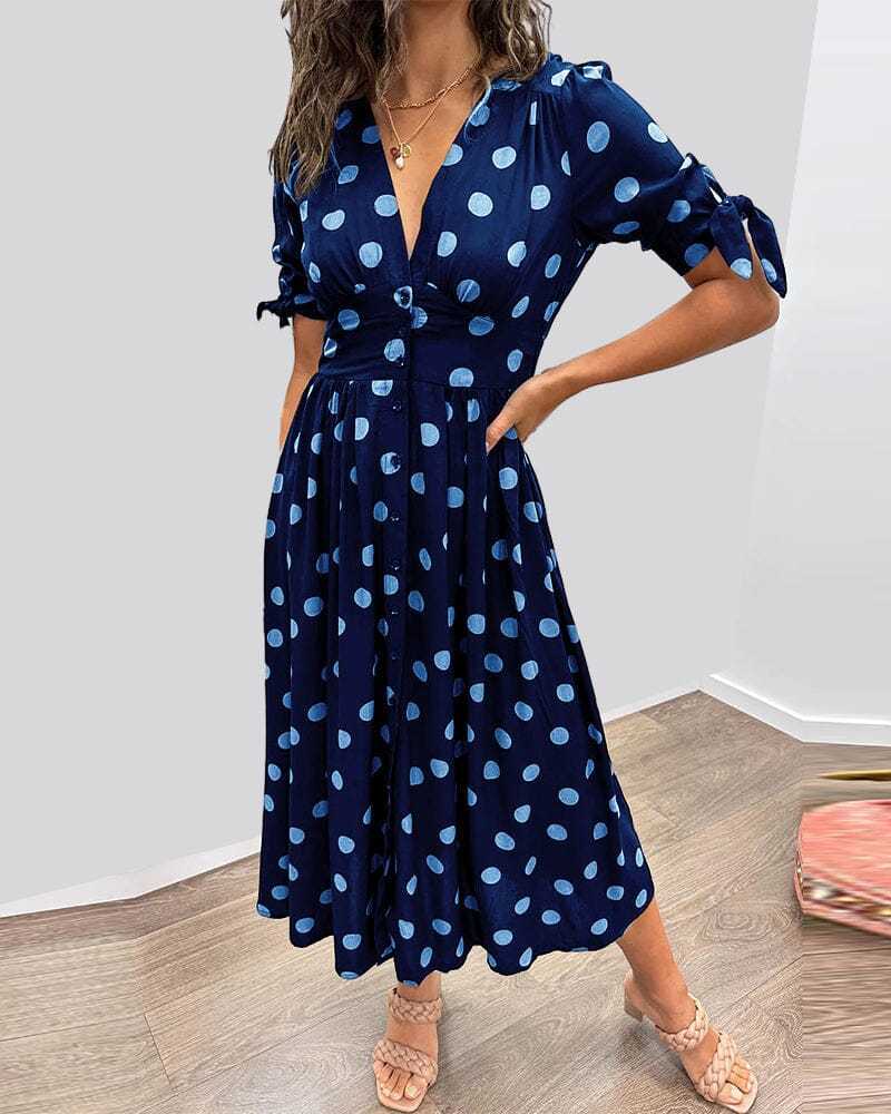 Navy blue wrap midi dress with light blue polka dots, tied sleeves front view