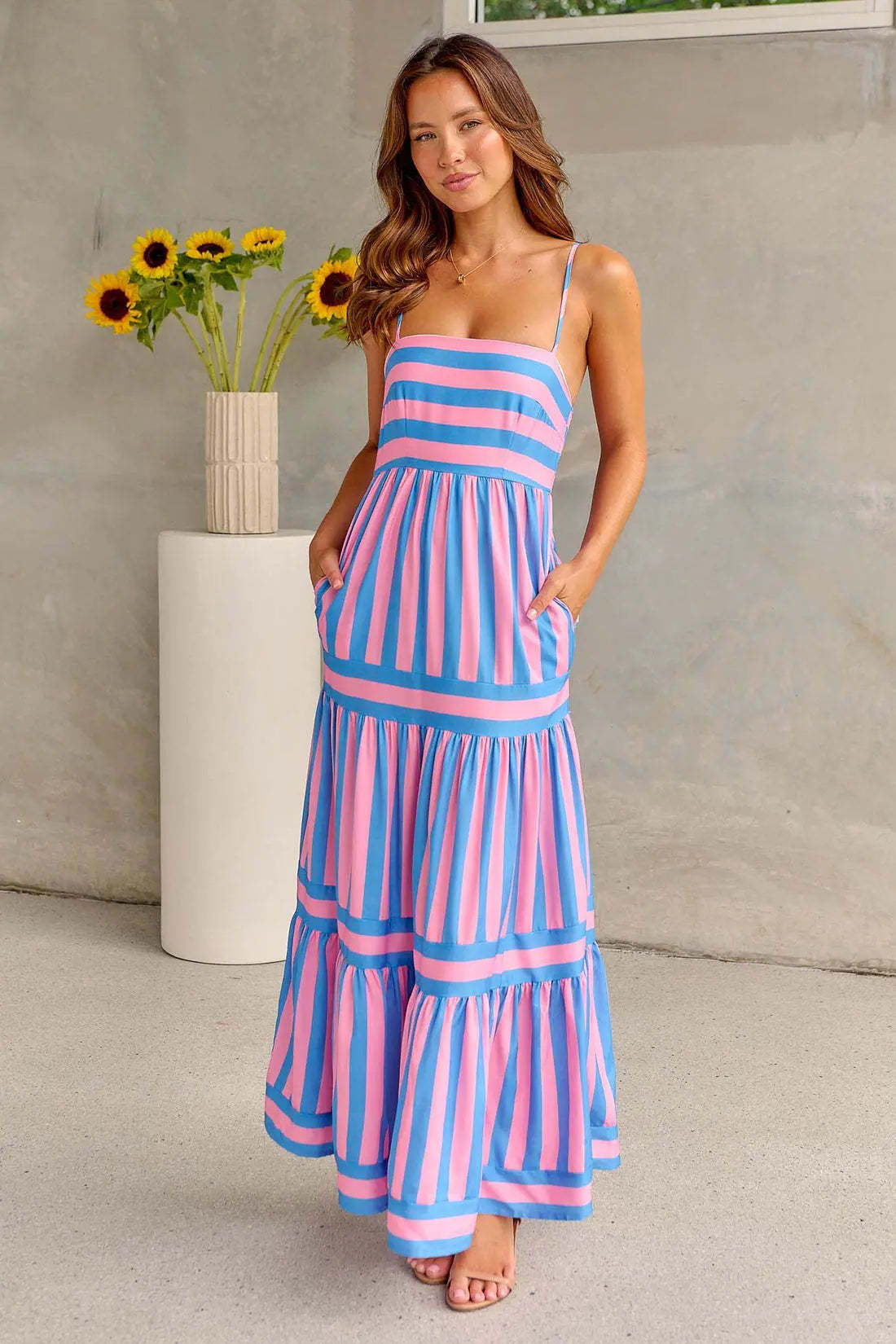 Pink and blue striped spaghetti strap maxi dress with side pockets and tiered layers