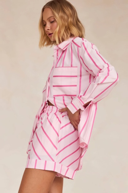 Back view of pink striped shirt showing geometric pattern and pleated shorts