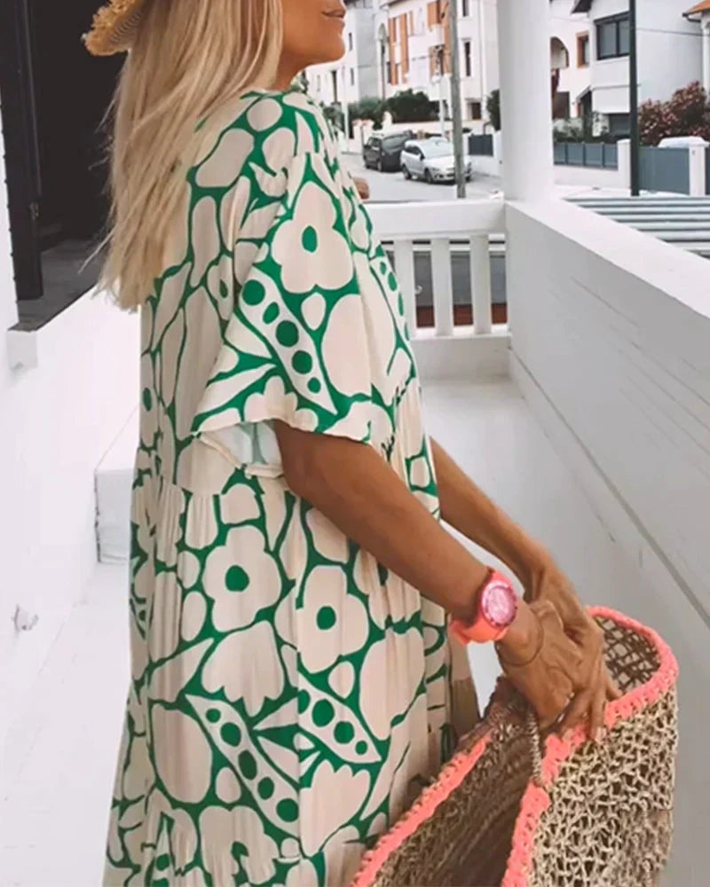 Back view of green floral maxi dress showing draped design