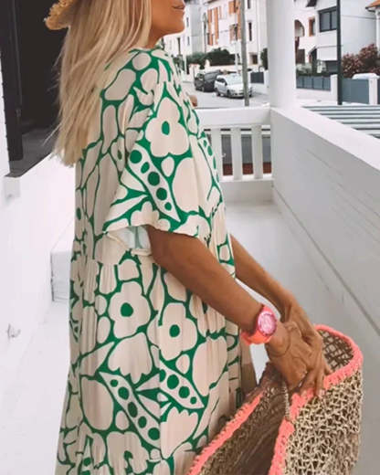 Back view of green floral maxi dress showing draped design
