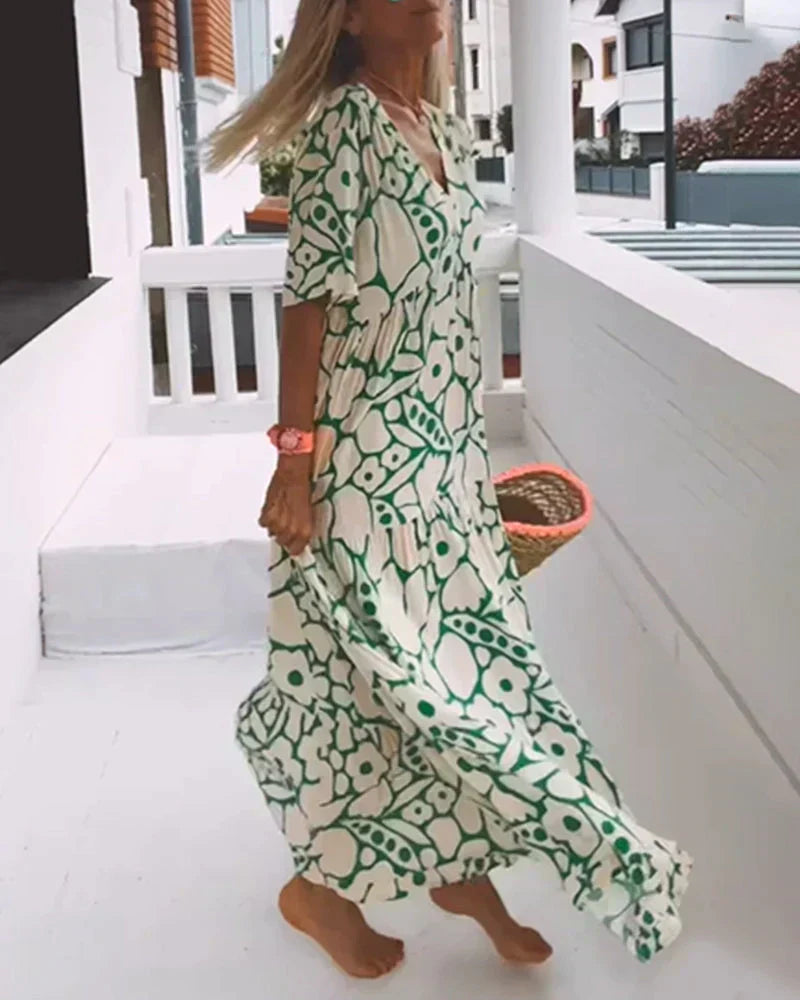 Side profile of cream and green botanical maxi dress with movement