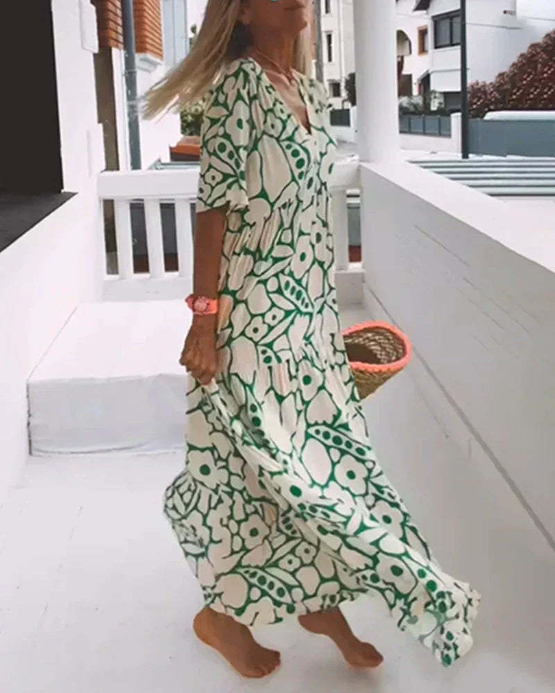 Side profile of cream and green botanical maxi dress with movement