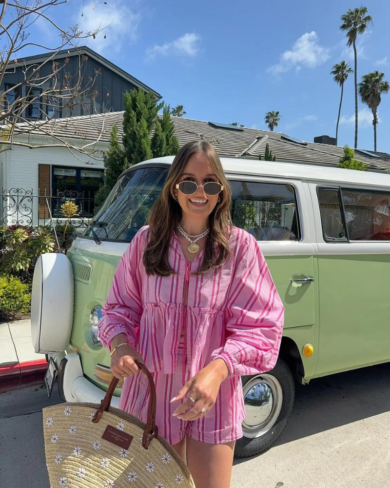 Woman in hot pink striped matching shorts set with peplum and long sleeves