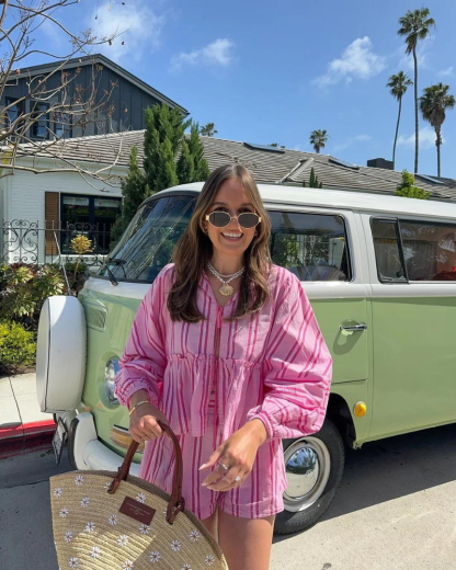 Woman in hot pink striped matching shorts set with peplum and long sleeves