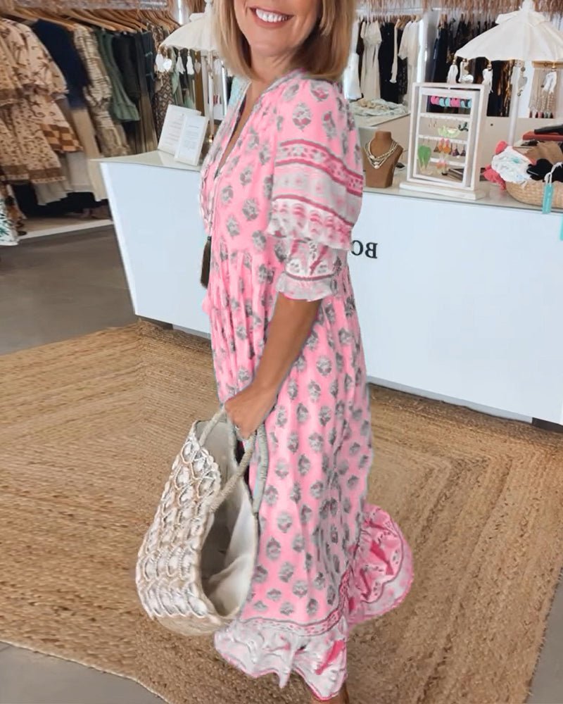 Side view of pink tiered maxi dress showing layered hem and patterned sleeves