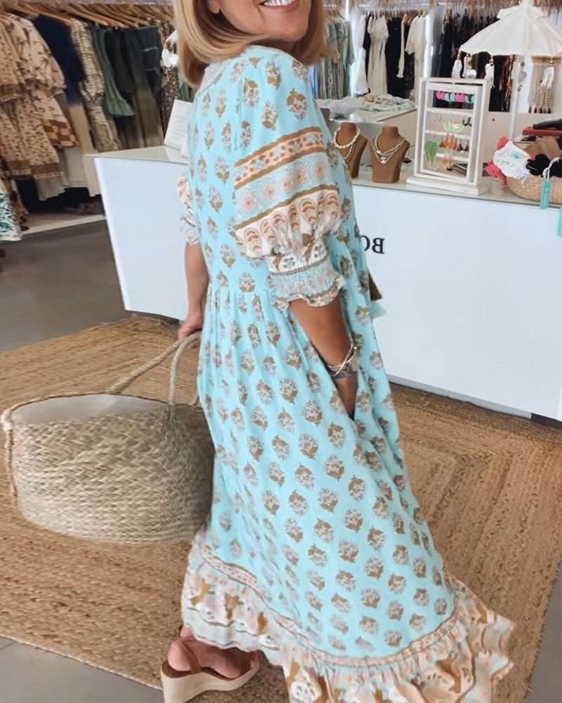 Back view of light blue floral maxi dress showing tiered layers and lace details
